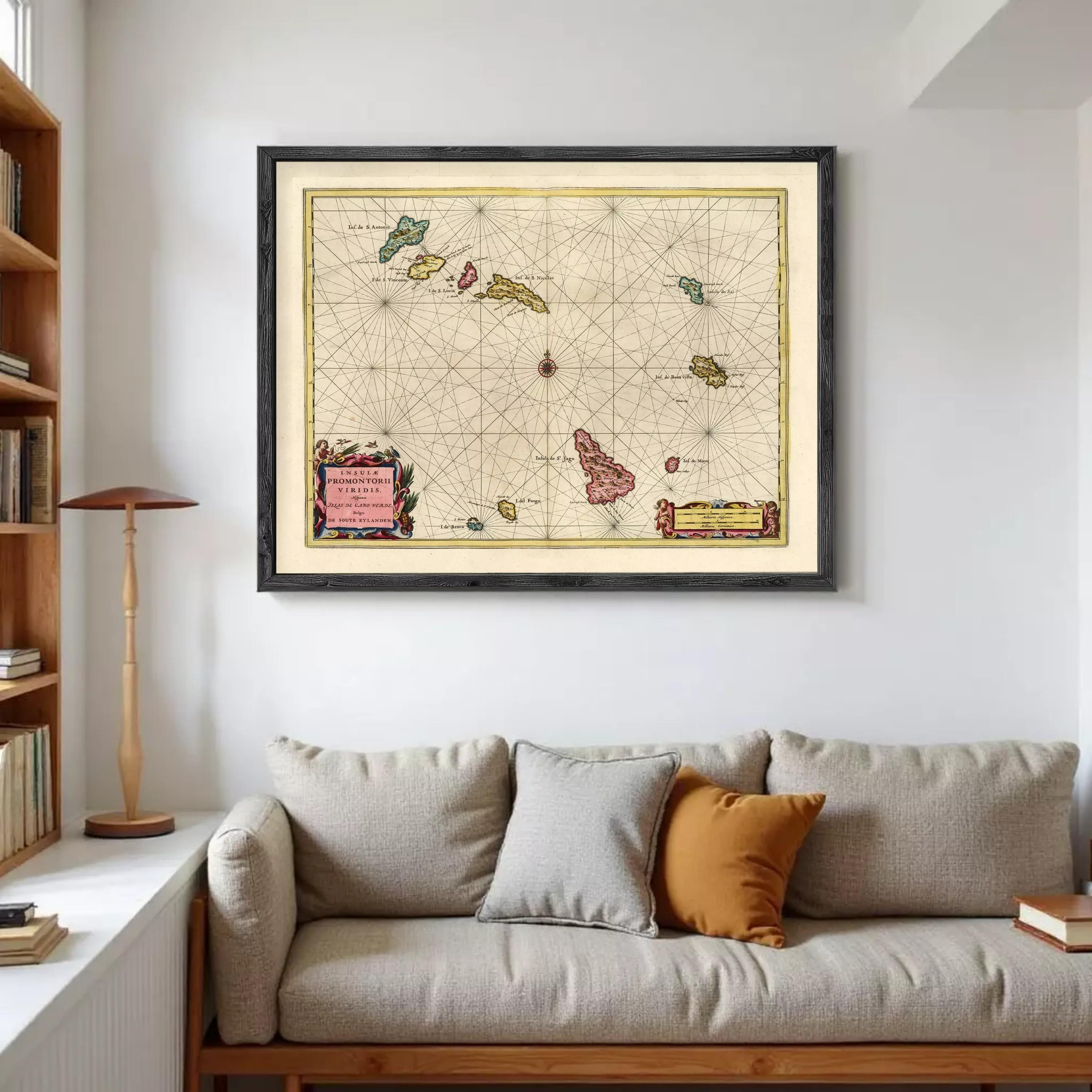 a large framed map hanging on a wall above a couch in a living room.