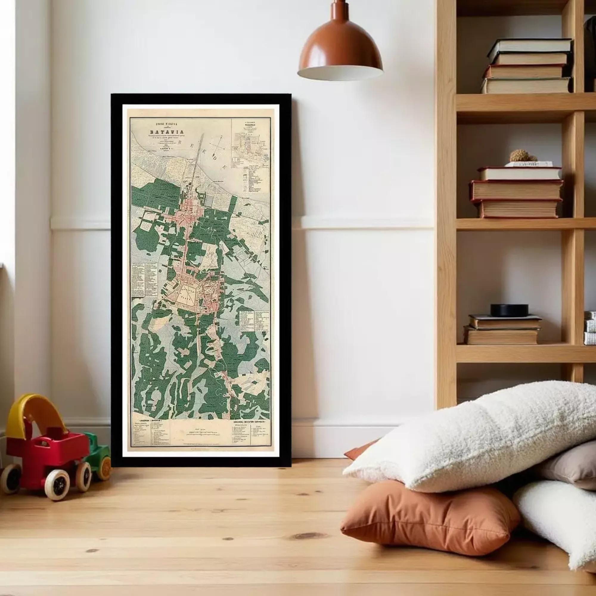 a framed map of a region, with a wooden bookshelf and a child's toy car in the foreground.
