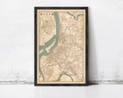 The image is a framed map of a city, likely from the 19th century, with a detailed layout of streets, rivers, and other geographic features.