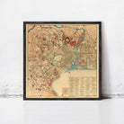 The image is a framed vintage map of a city, likely from the 19th century, with various landmarks and streets depicted in a detailed and colorful manner.