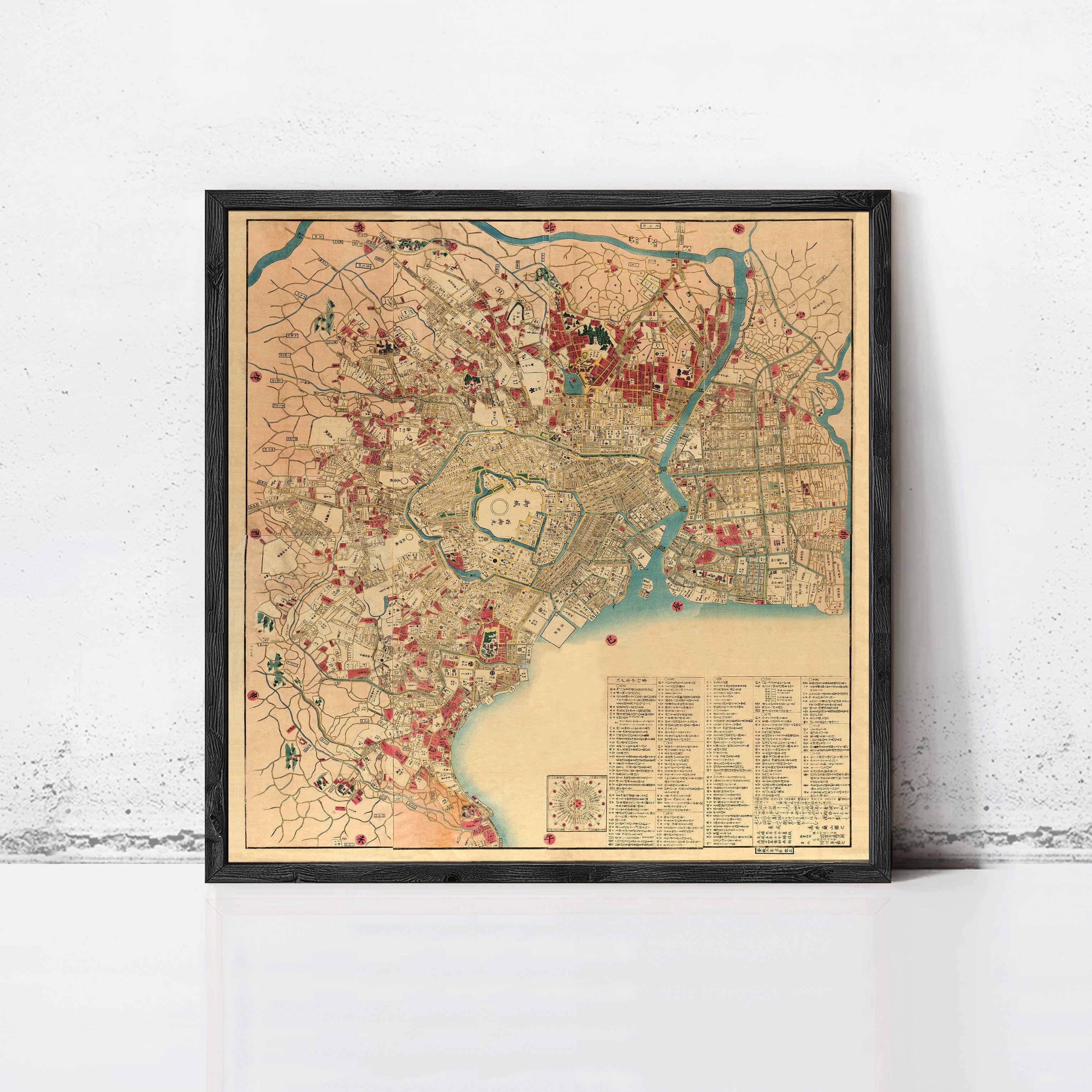 The image is a framed vintage map of a city, likely from the 19th century, with various landmarks and streets depicted in a detailed and colorful manner.