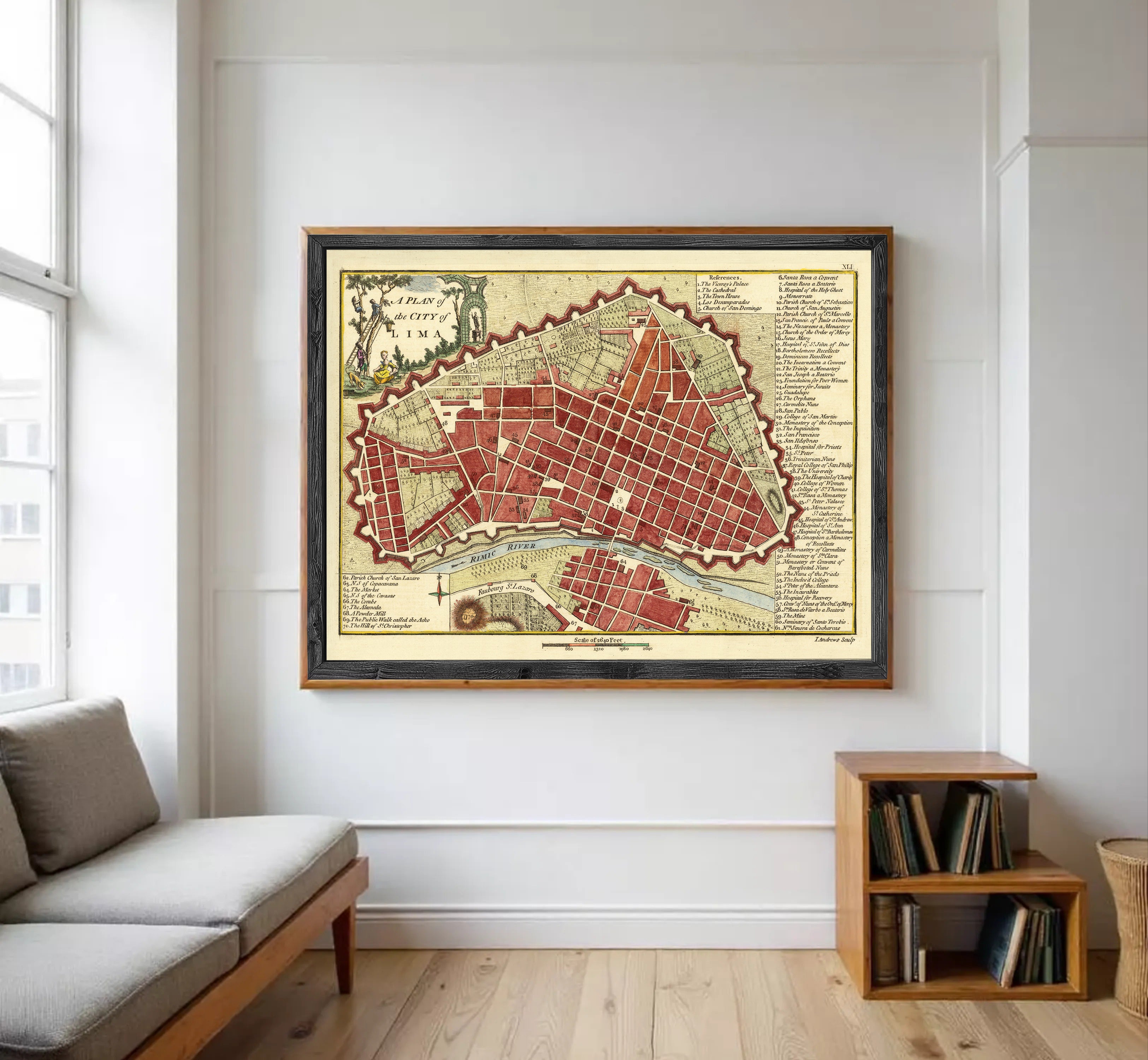 a large framed map of a city hanging on a white wall in a living room.
