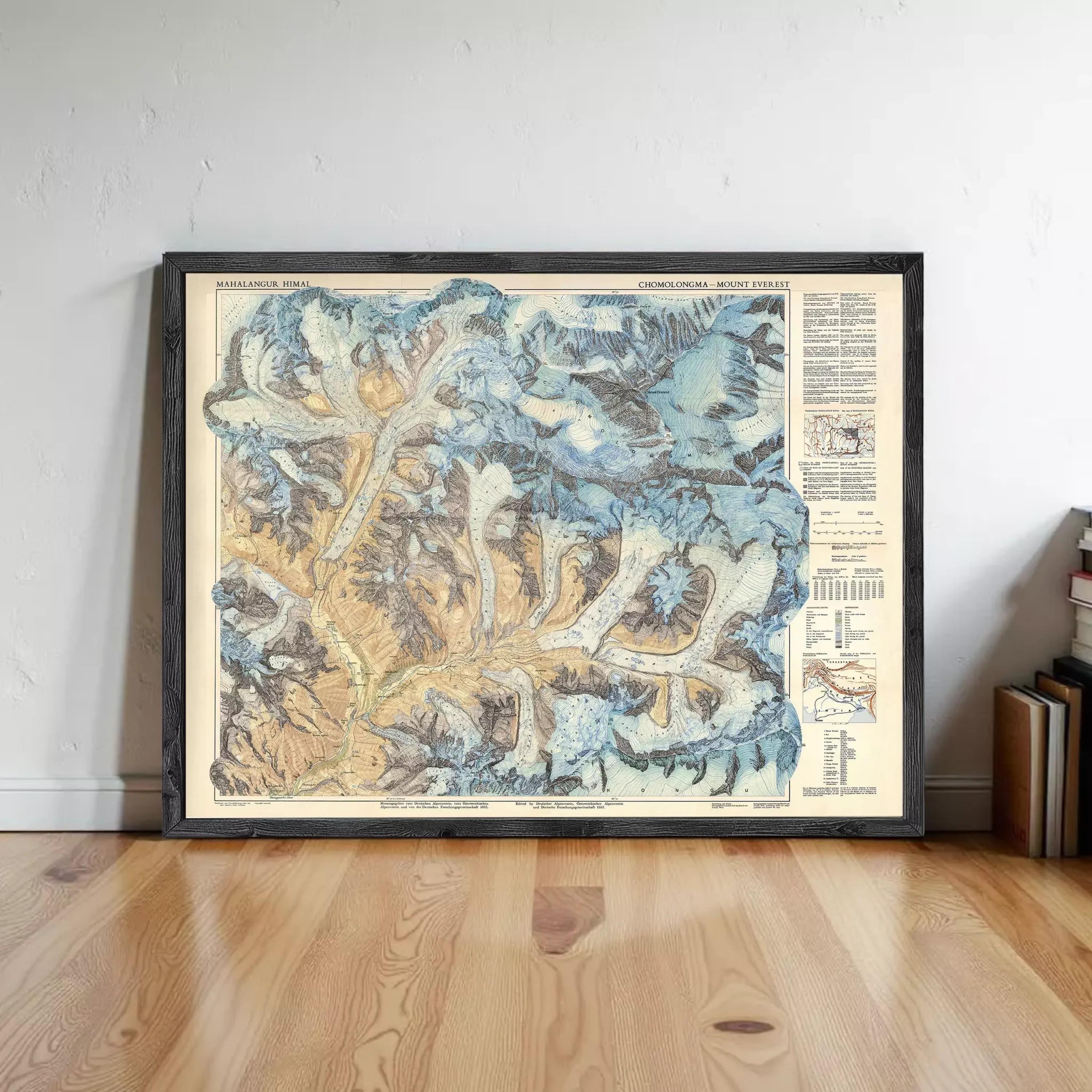 The image is a framed vintage map of the Himalayan mountain range, displayed on a wooden floor against a white wall.