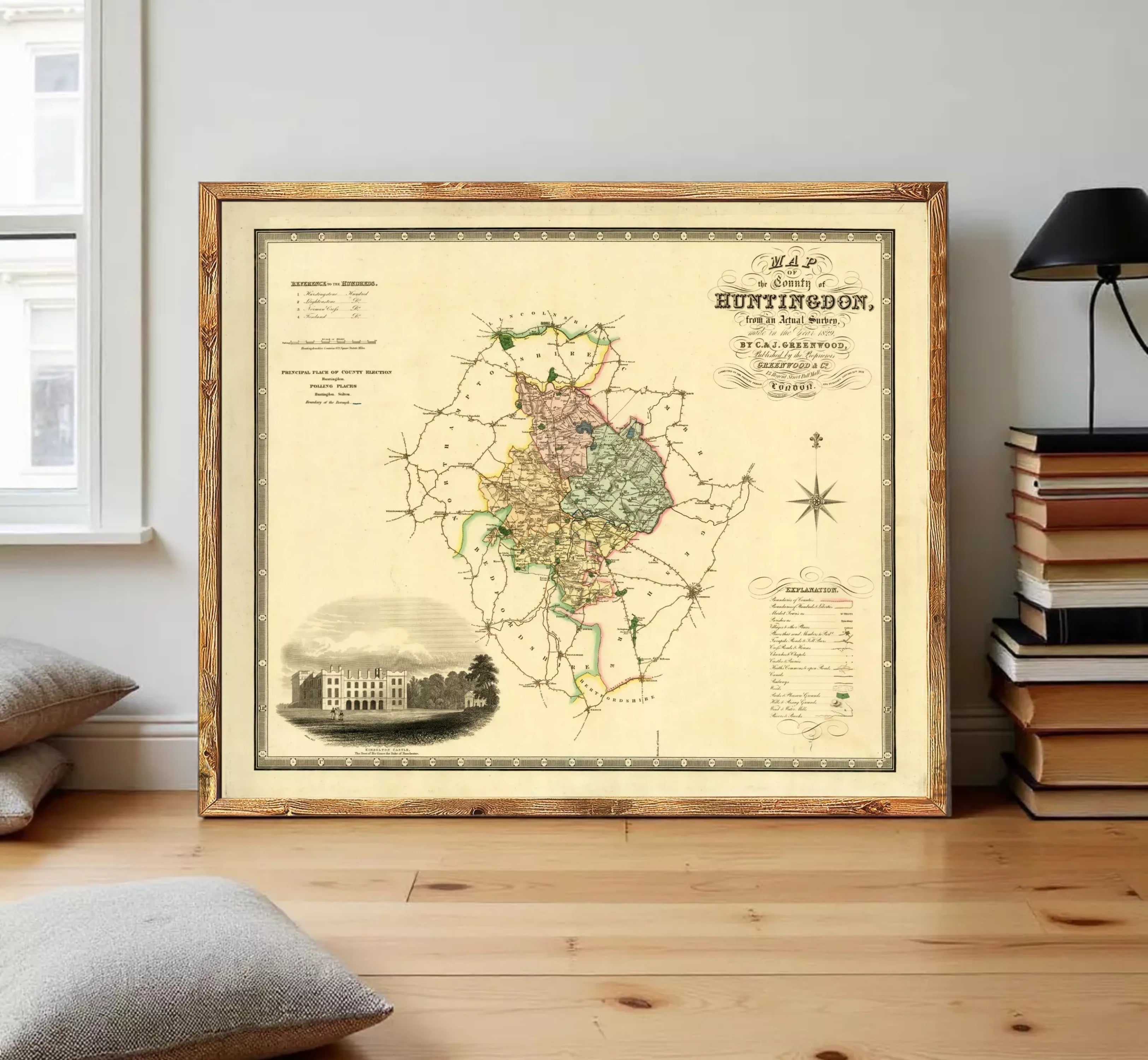 The image is a framed antique map of Huntingdon, showing a detailed map of the area with various landmarks and geographical features.