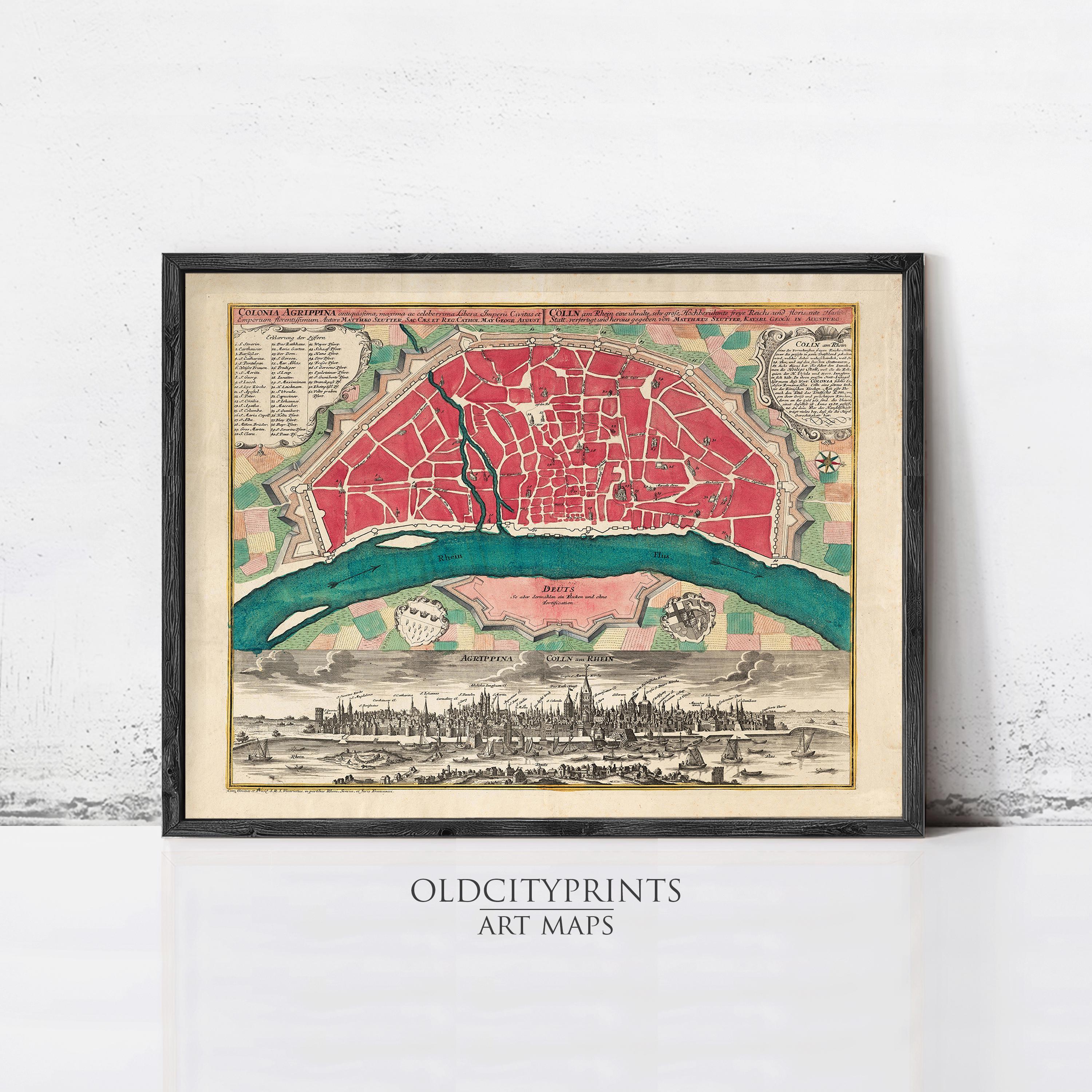 The image is a framed vintage map of a city, depicting a detailed and colorful cityscape with a river running through it.