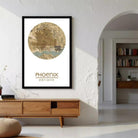 a framed map of Phoenix, Arizona, hanging on a wall in a room with a wooden cabinet below it.