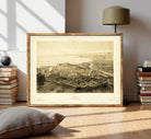 The image is a framed print depicting a cityscape, likely from the 19th century, with a detailed and intricate view of the city's layout and architecture.