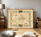 The image is a framed vintage map of London, featuring various landmarks and transportation routes.