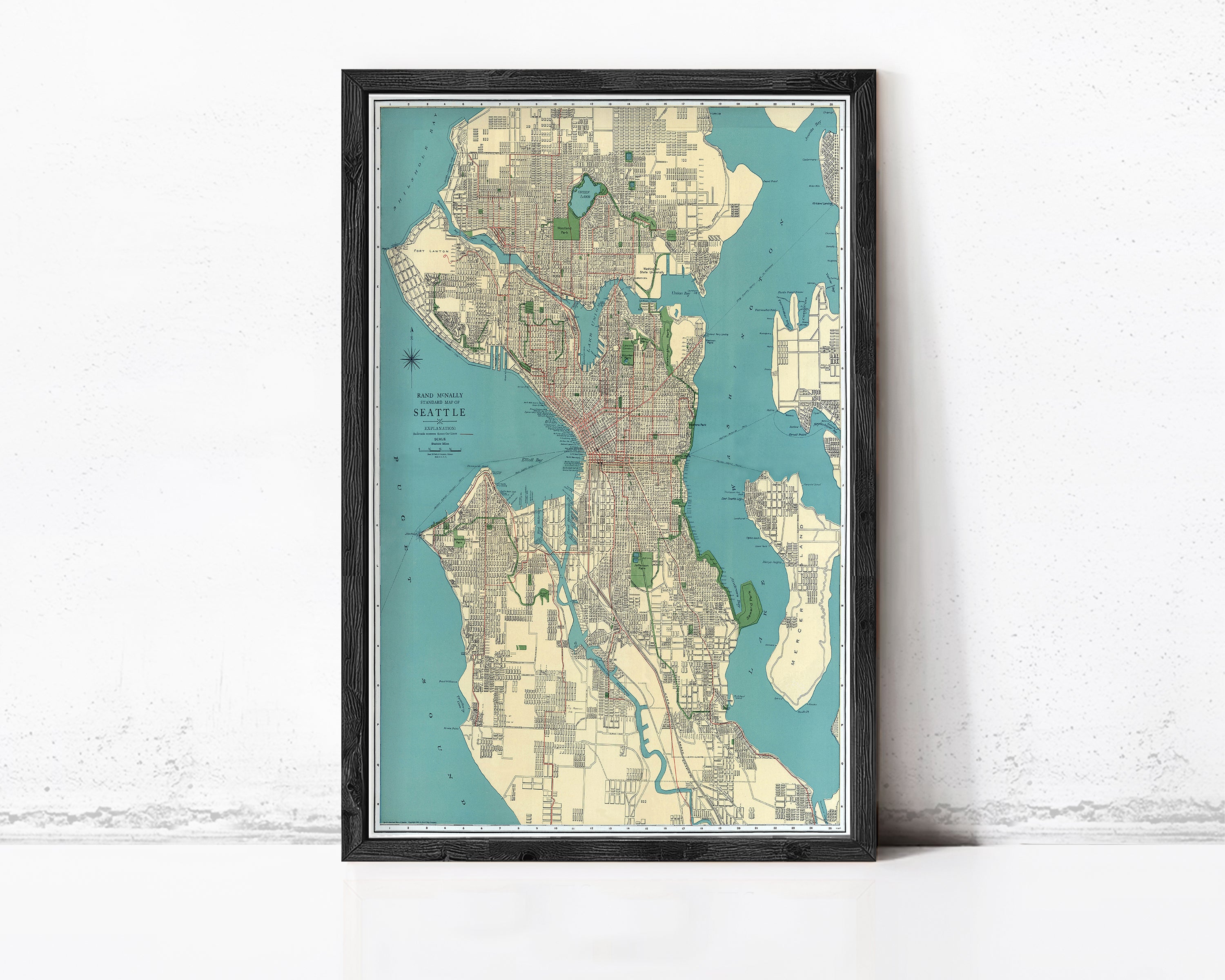 The image is a framed map of Seattle, Washington, with a black border and a light blue background.