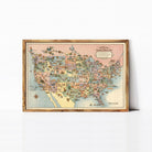 The image is a framed vintage map of the United States, depicting various landmarks and regions in a colorful and detailed manner.