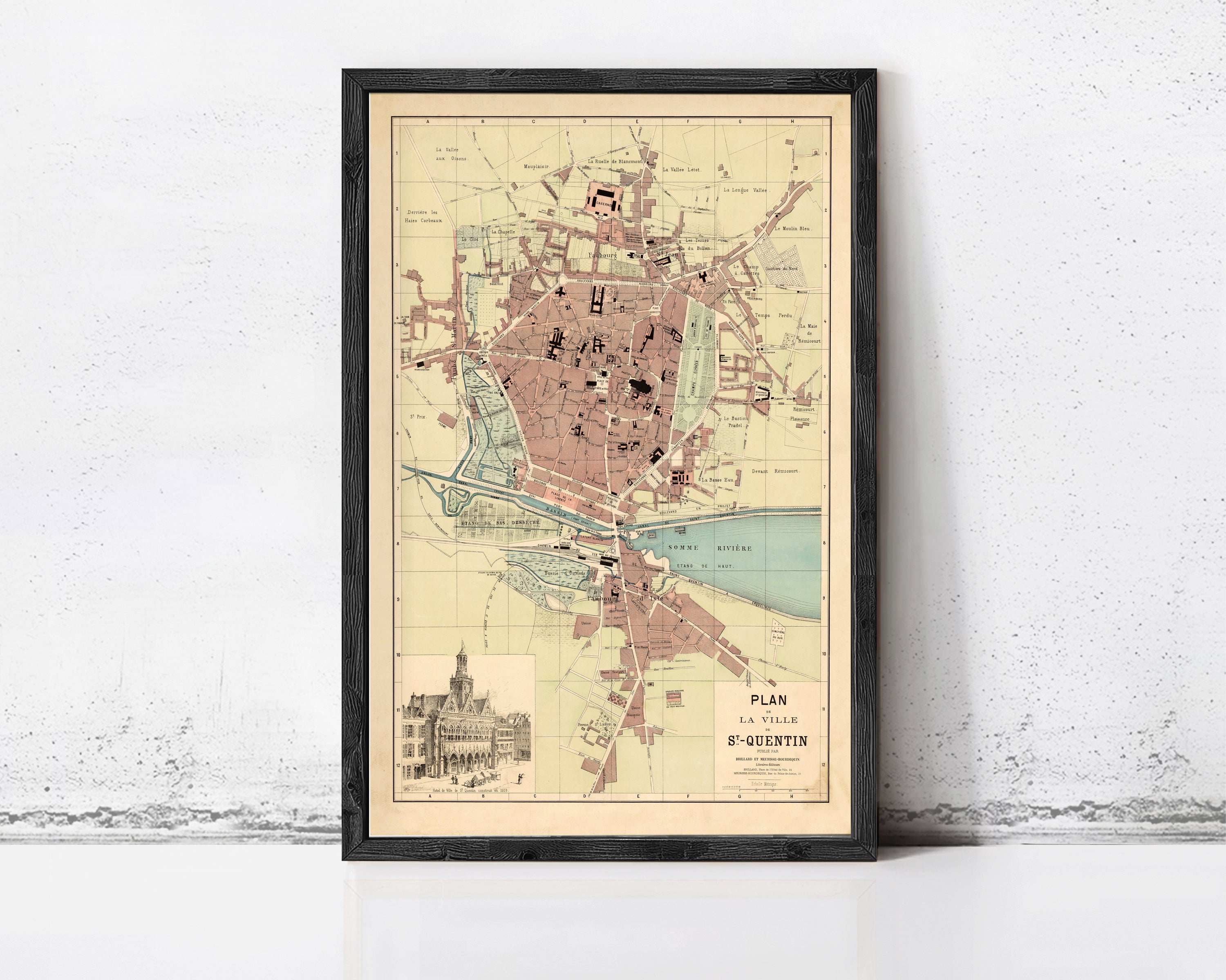 The image is a framed vintage map of a city, depicting a detailed layout of streets, buildings, and other landmarks.