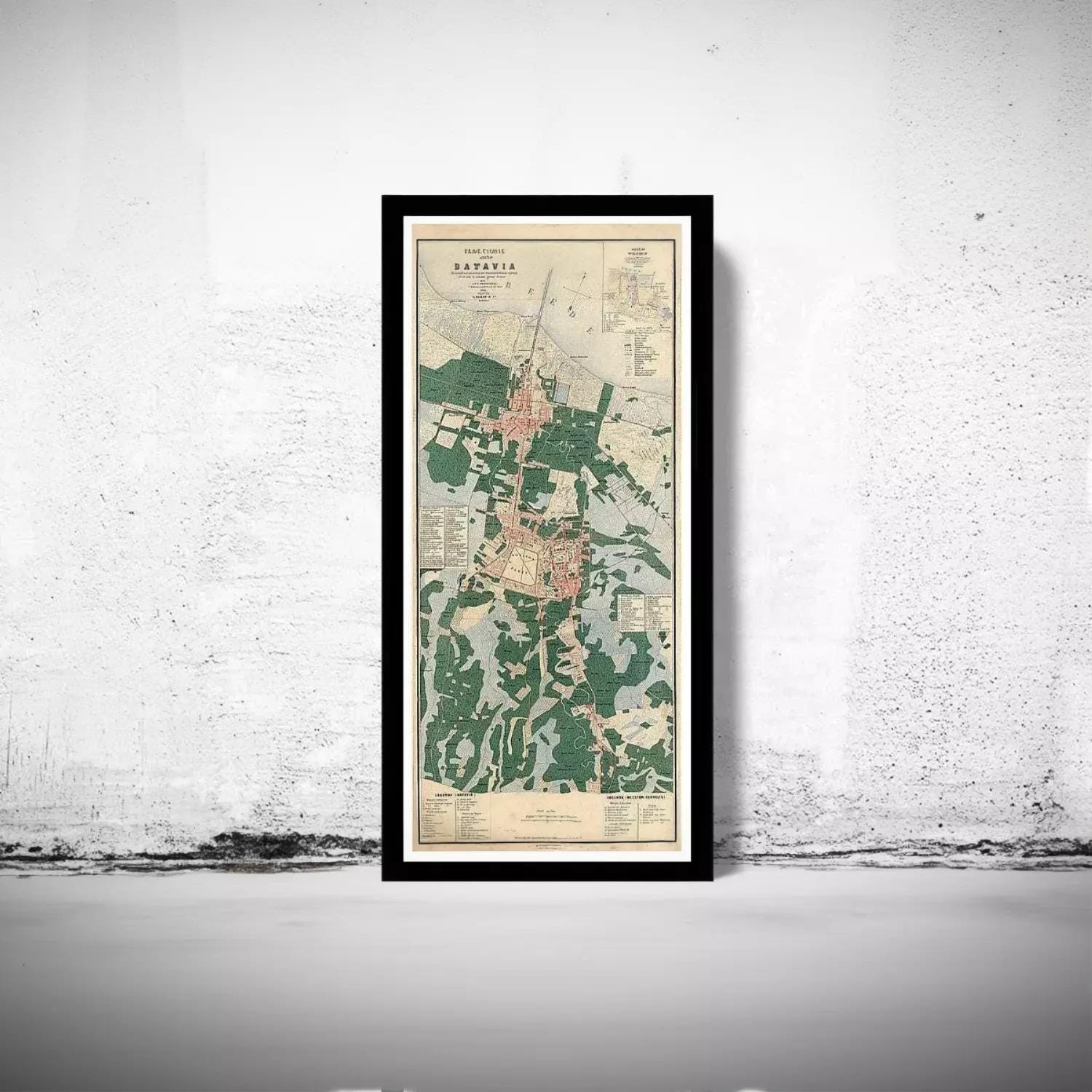A framed map of a city or region, with various landmarks and geographical features depicted.