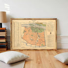 The image is a framed vintage map of a city, likely Paris, with detailed information about the city's attractions and landmarks.