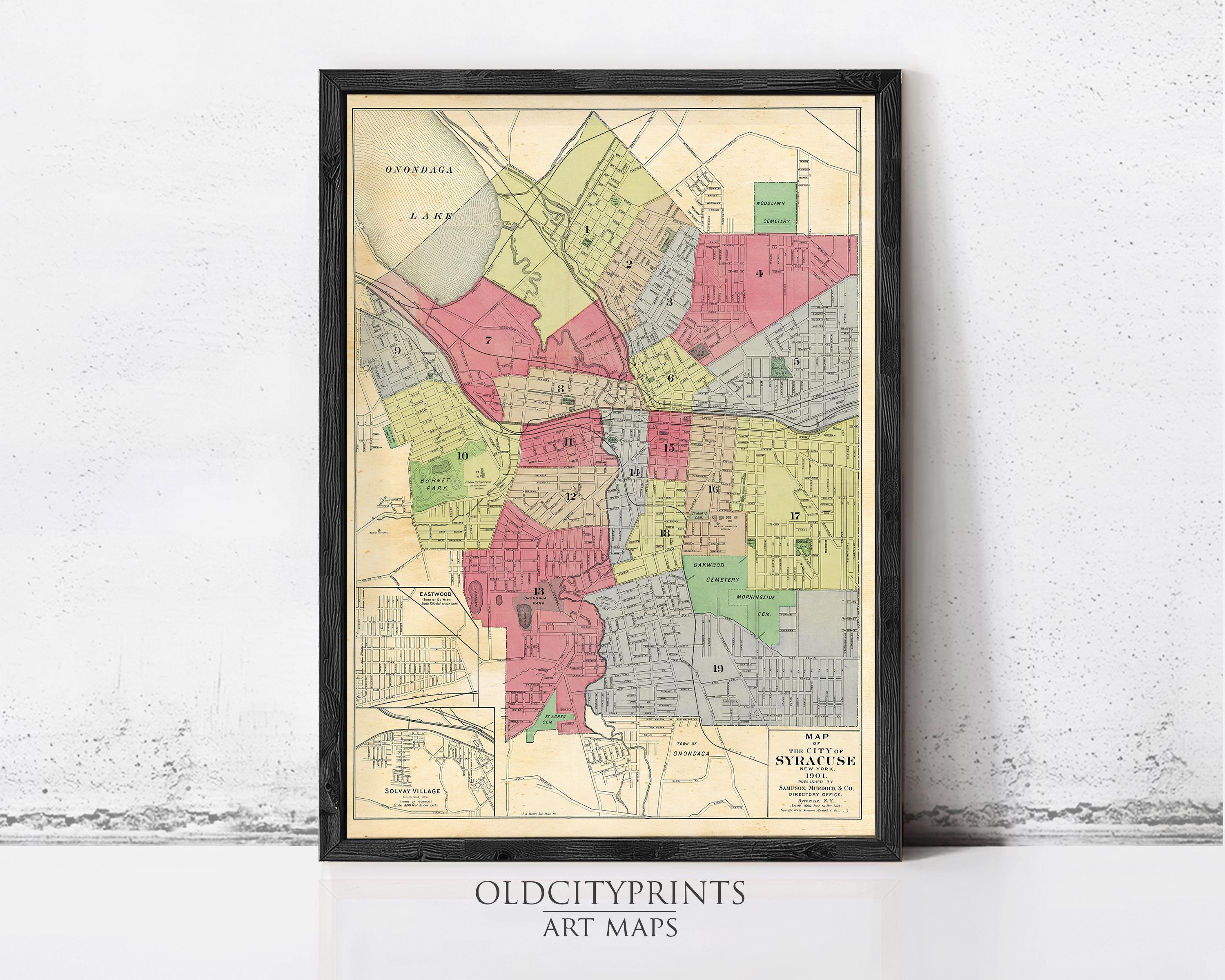 The image is a framed vintage map of a city, likely from the early 20th century, depicting various neighborhoods and streets.