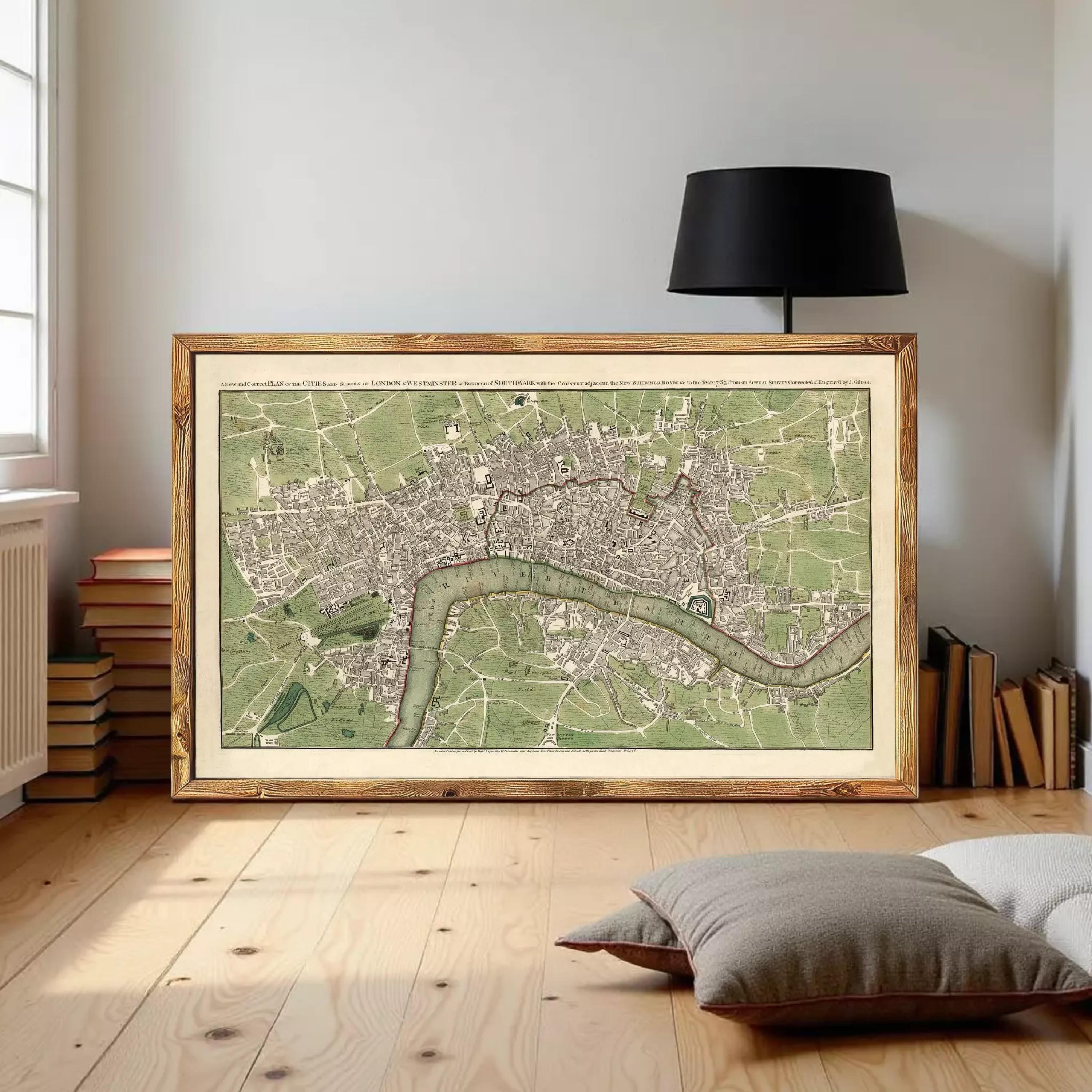 A framed map of London, England, with a river running through the city.