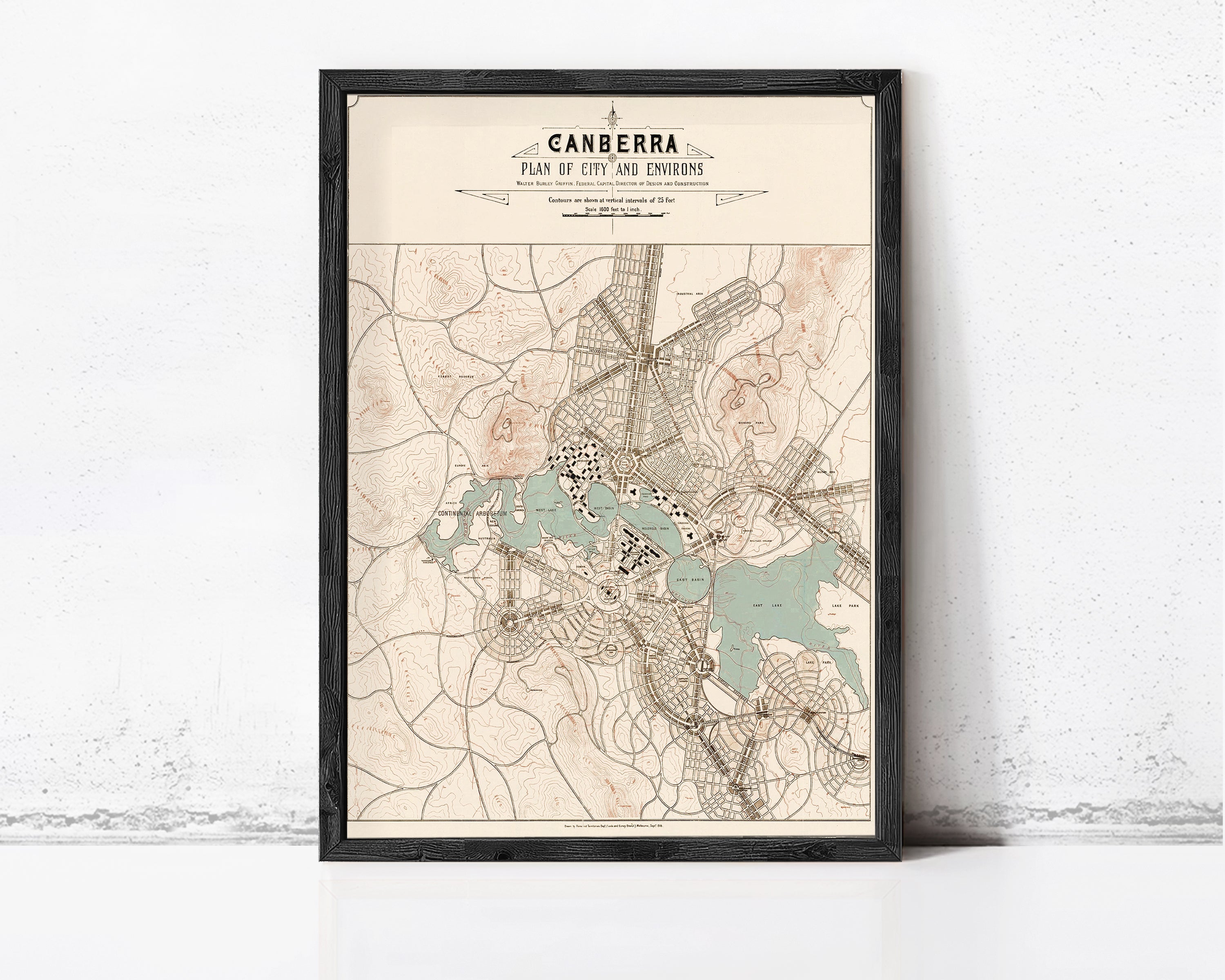 The image is a framed map of the city of canberra, Australia, depicting the city's layout and surrounding areas.