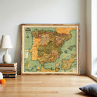 a large framed map of Spain and Portugal, with a vintage style and a wooden frame. The map is displayed on a wall in a room with a lamp and some books nearby.