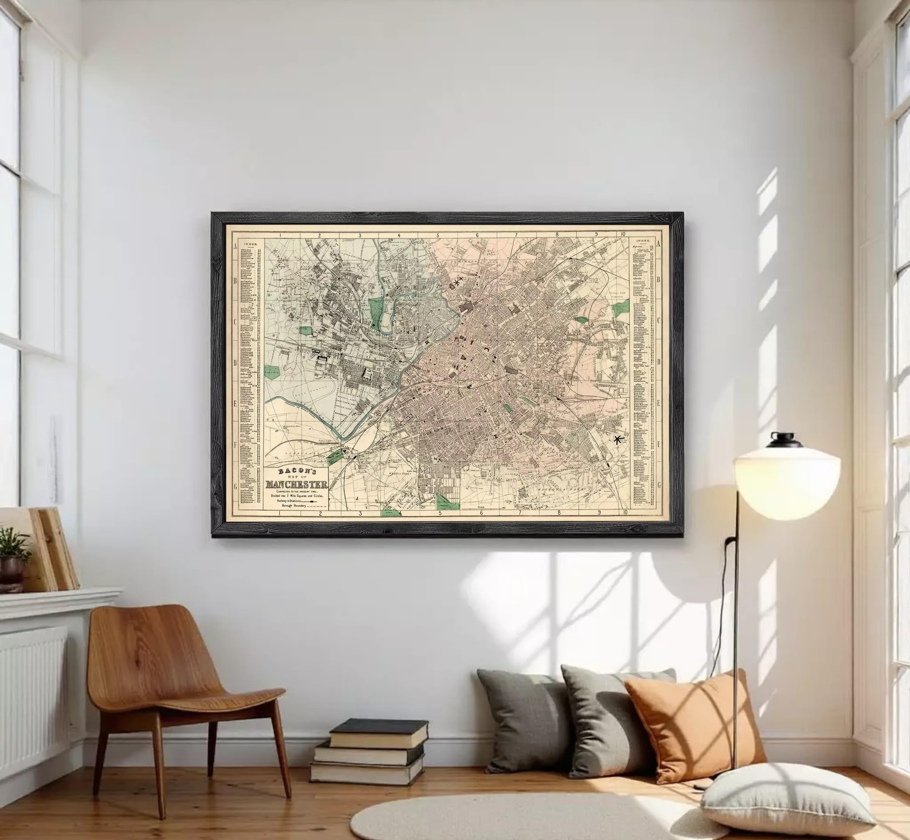 The image is a framed vintage map of a city, likely from the early 20th century, displayed on a white wall.