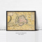 The image is a framed vintage map of a city, likely from the 17th century, with detailed cartography and a historical context.