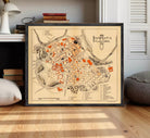 The image is a framed map of the city of Pamplona, Spain, depicting the layout and various landmarks within the city.