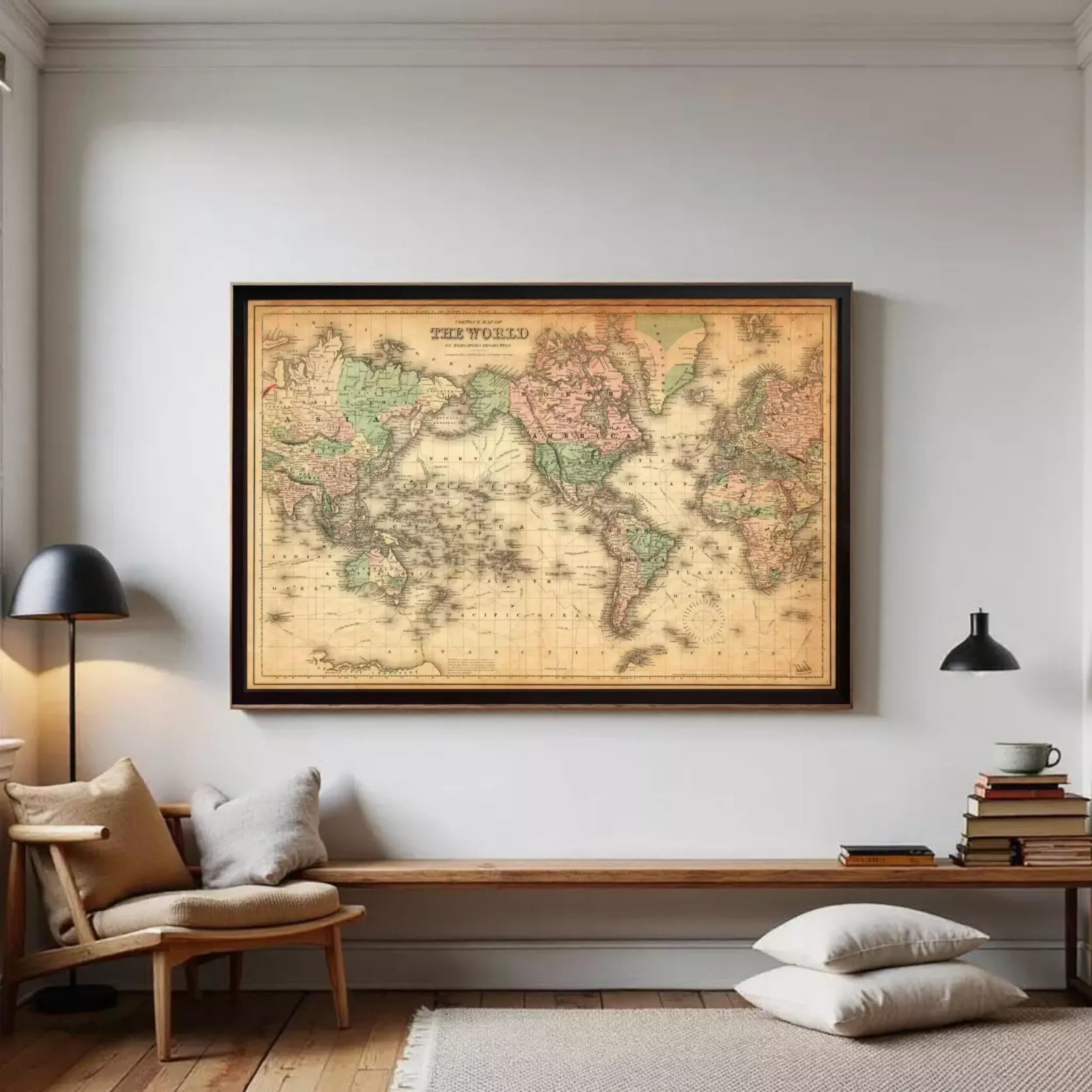 a large world map hanging on a wall in a room with a wooden bench, a lamp, and a stack of books.