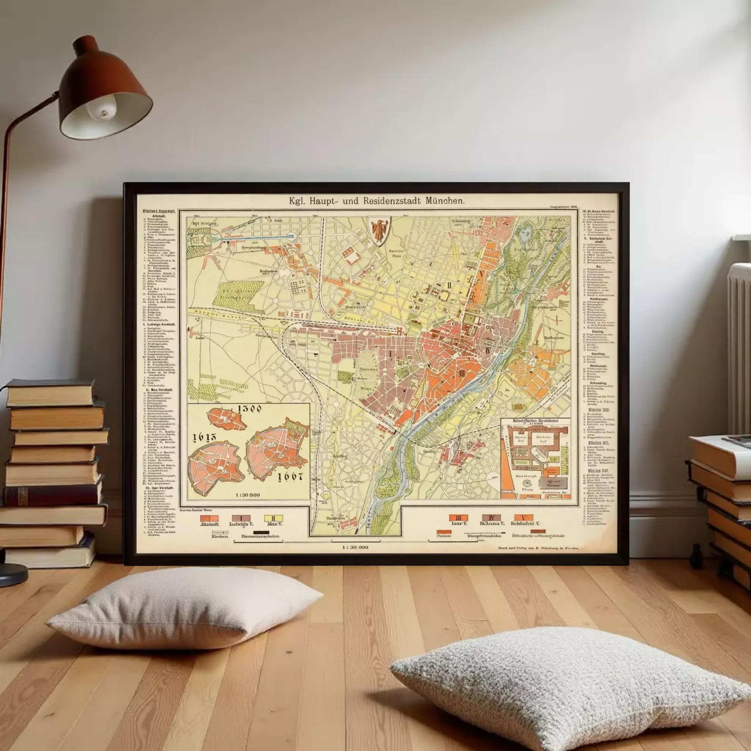 a large framed map of a city, with various labels and details, placed on a wooden floor in a room with a lamp and books.