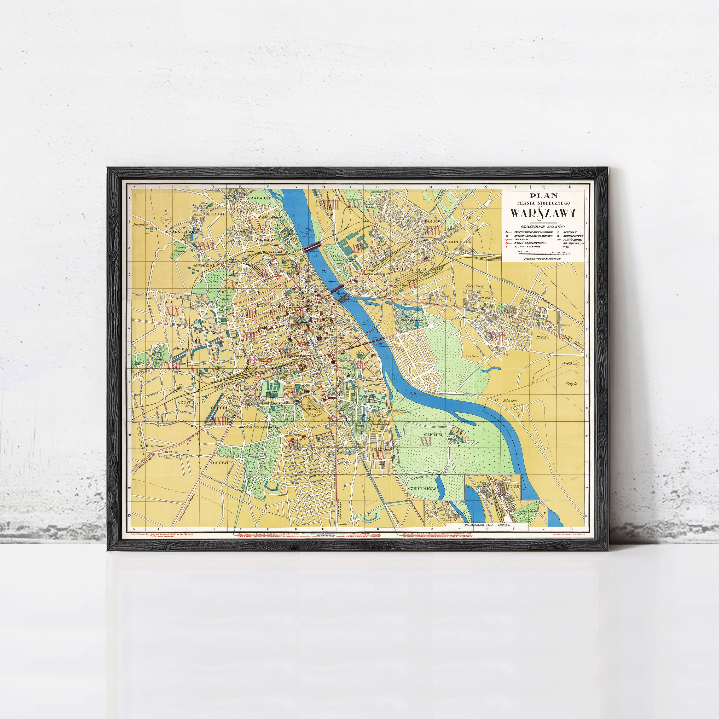The image is a framed map of Warsaw, Poland, depicting the city's streets, landmarks, and surrounding areas.