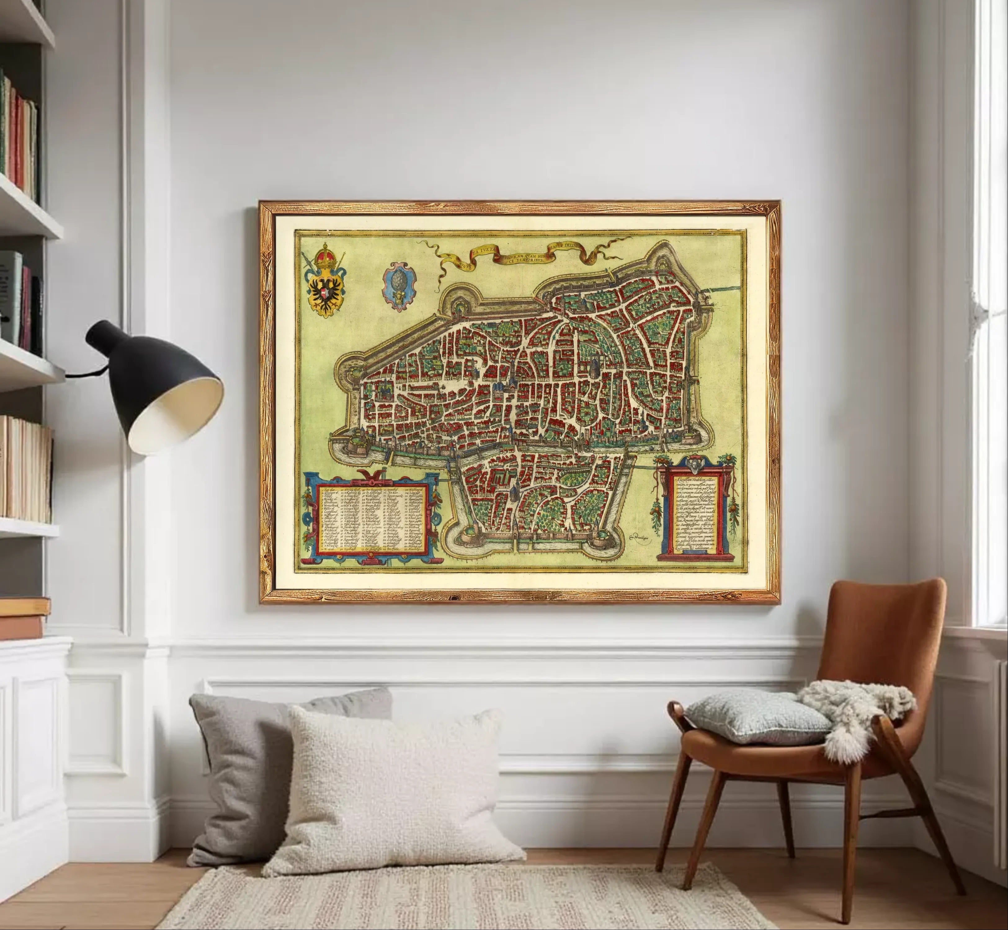 The image is a framed antique map of a city, likely from the Middle Ages, with intricate details and a decorative border.