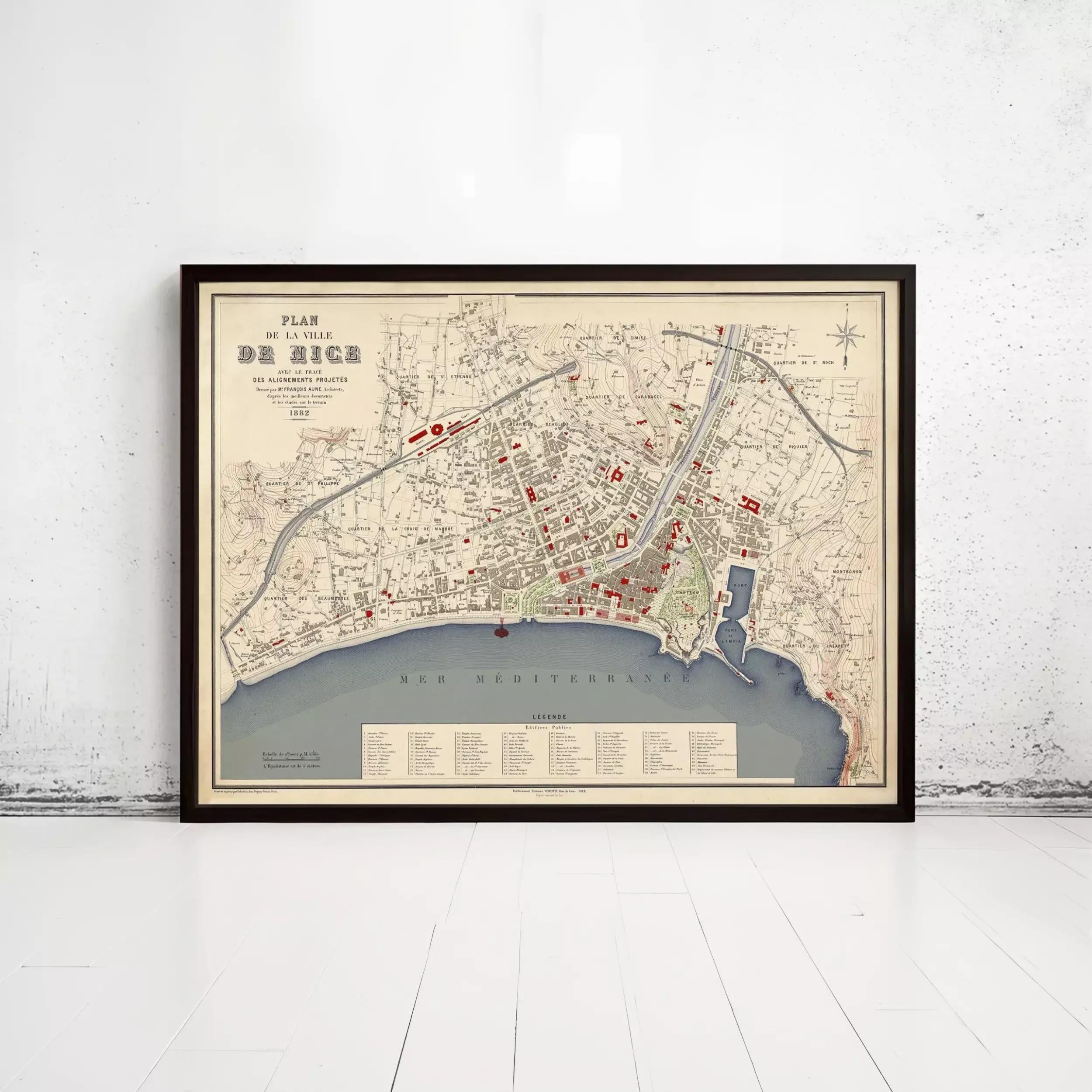 The image is a framed map of a city, likely a historical or geographical map, displayed on a wall.
