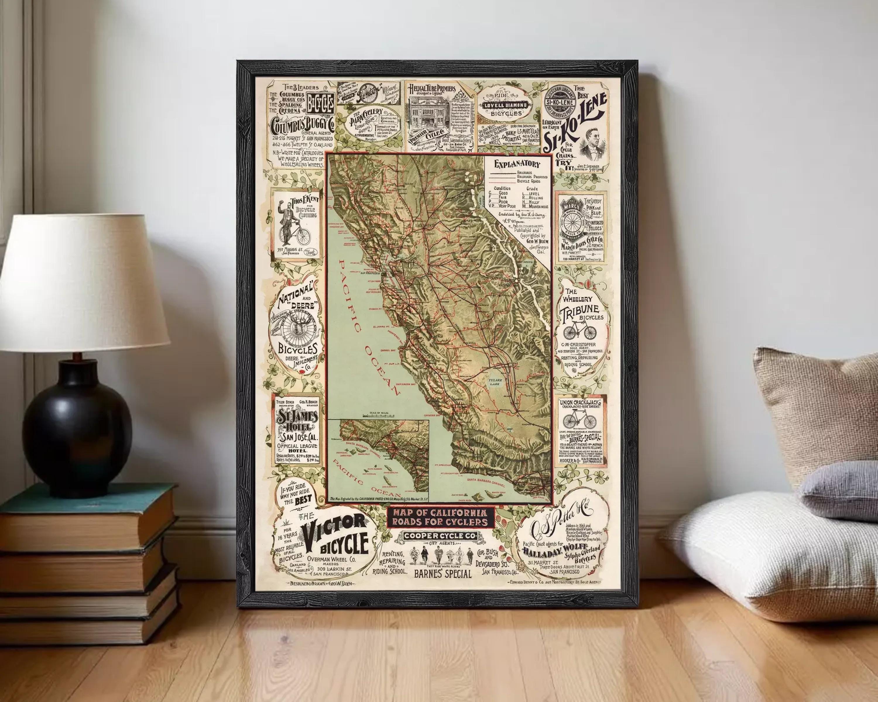 The image is a framed vintage map of California, featuring various advertisements and illustrations related to cycling and transportation.