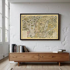 a large, framed map hanging on a white wall above a wooden console table.