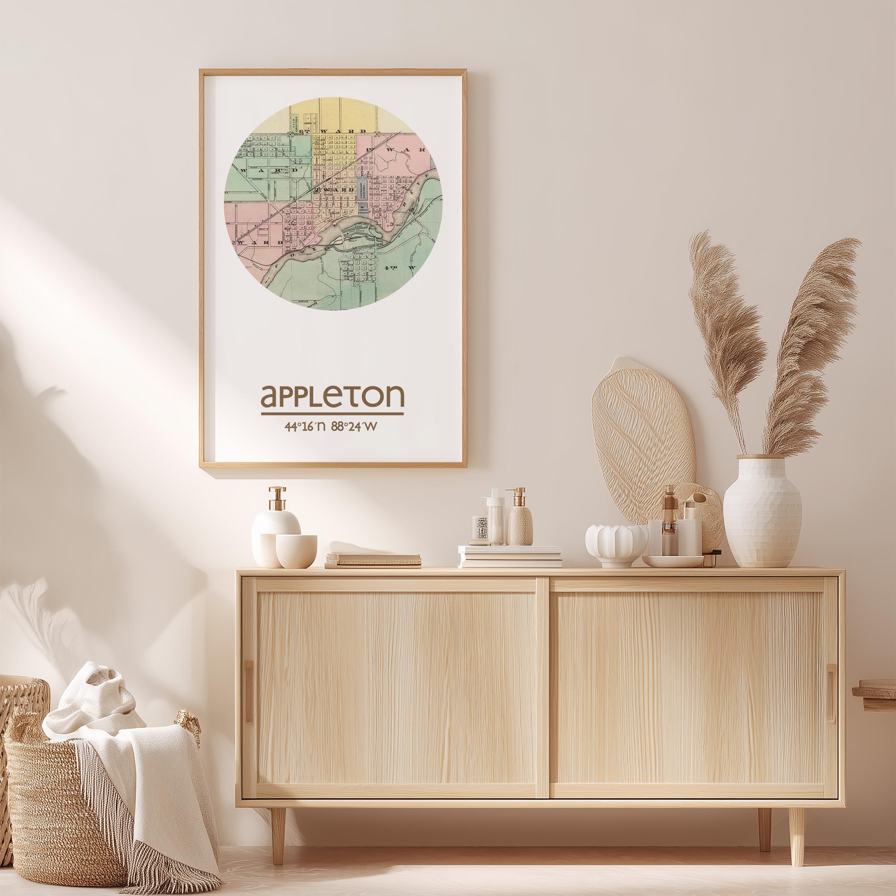 a framed map of Appleton, Wisconsin, hanging on a wall above a wooden cabinet. The cabinet has various items on it, including a vase with pampas grass, a bottle, and a book.