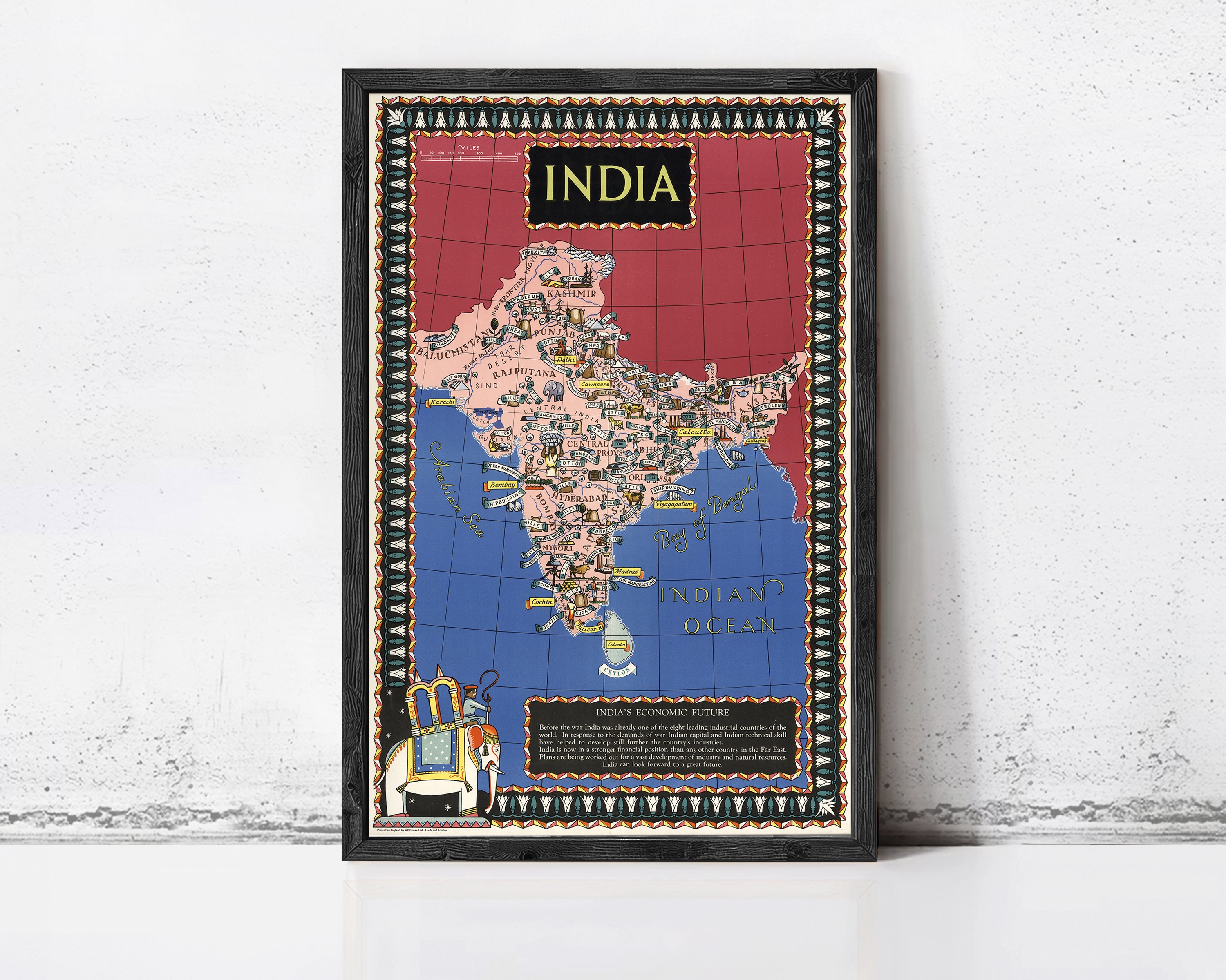 The image is a framed poster of India, featuring a colorful map of the country with various landmarks and symbols.