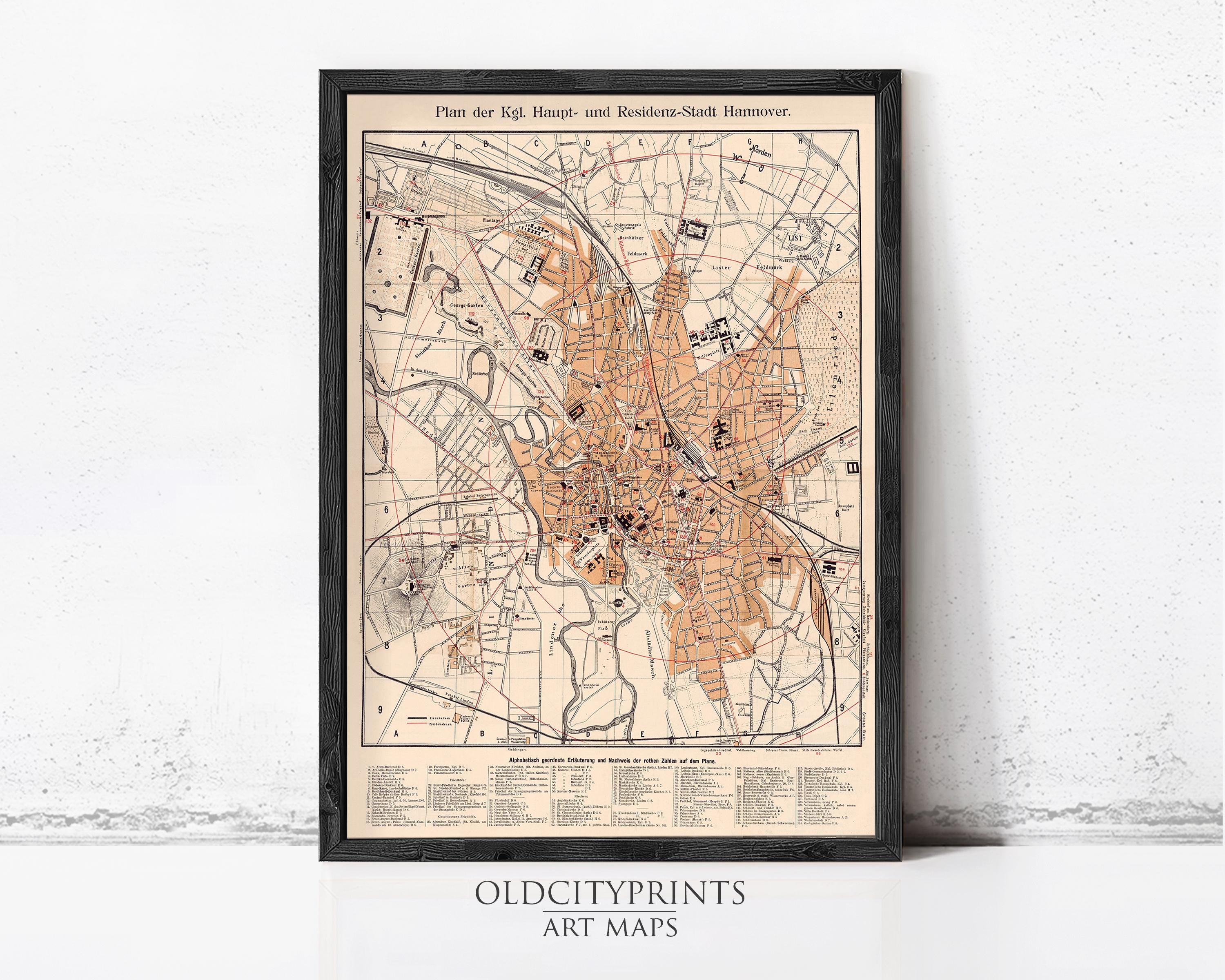 The image is a framed vintage map of a city, likely from the 19th century, with detailed street maps and labels.