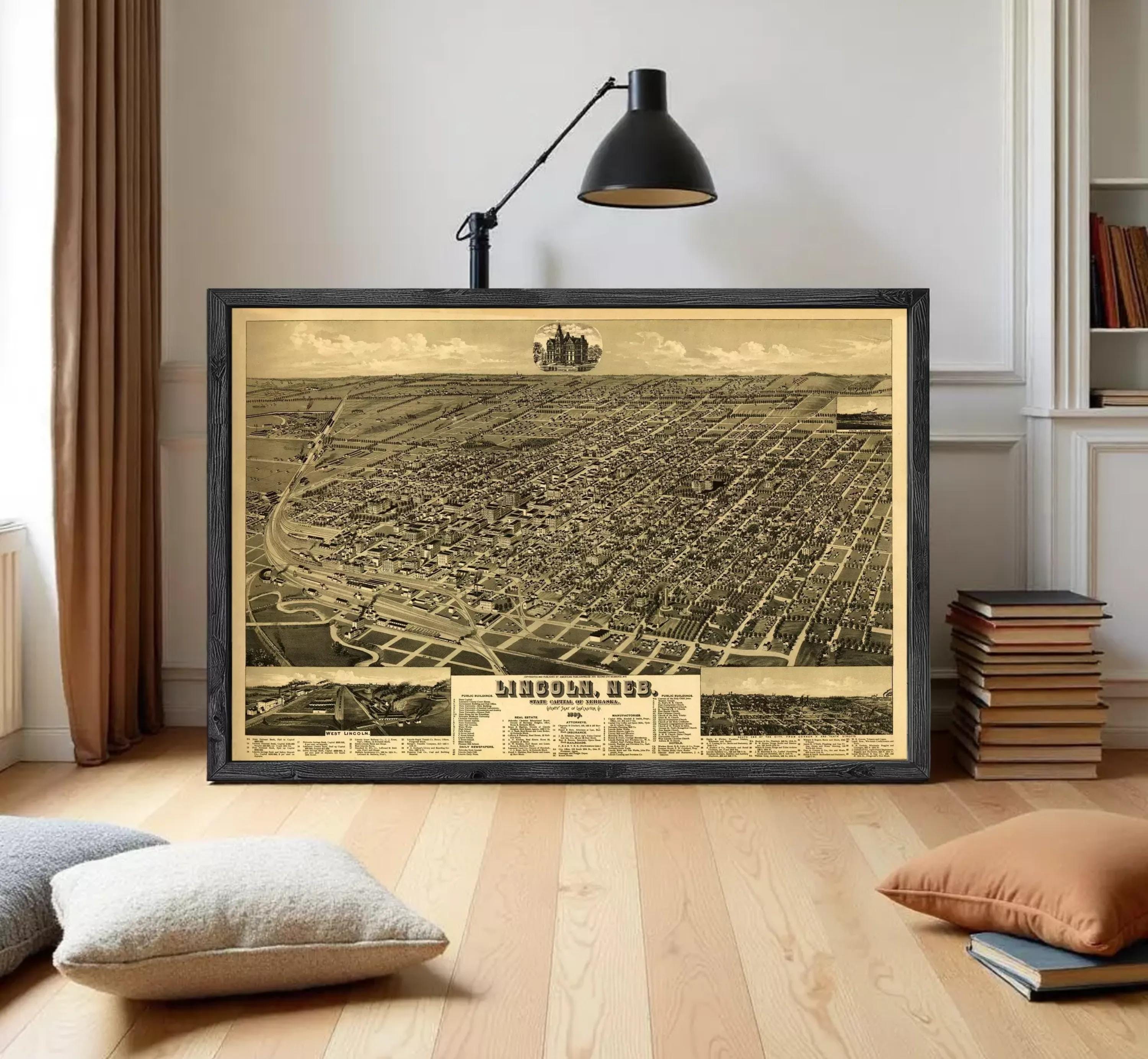 The image is a framed vintage map of a city, depicting a detailed aerial view of the urban landscape.