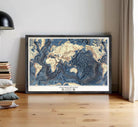 The image is a framed map of the world, specifically depicting the floor of the oceans.