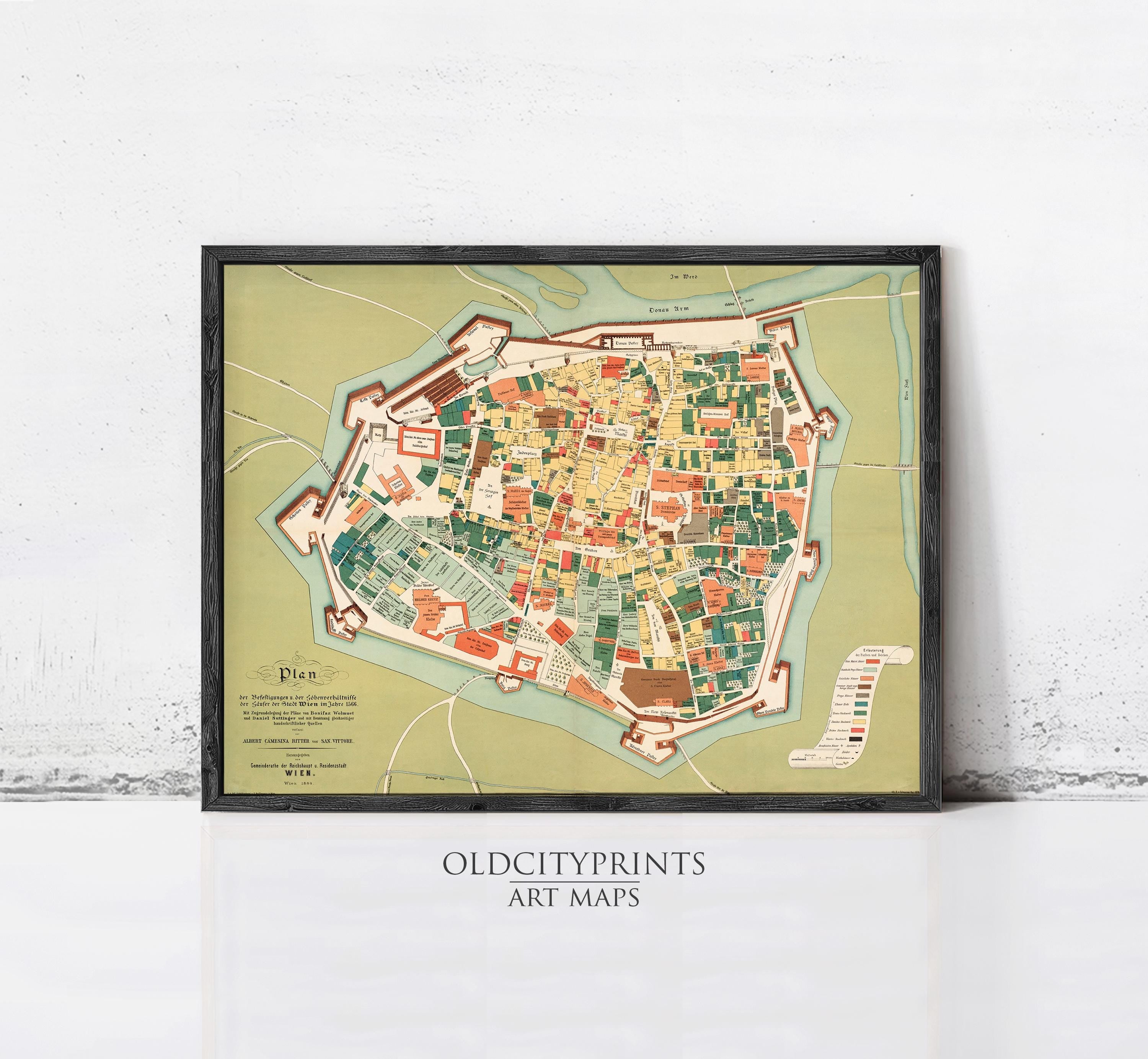 The image is a framed art print depicting a detailed map of a city, likely a historical or cultural city.