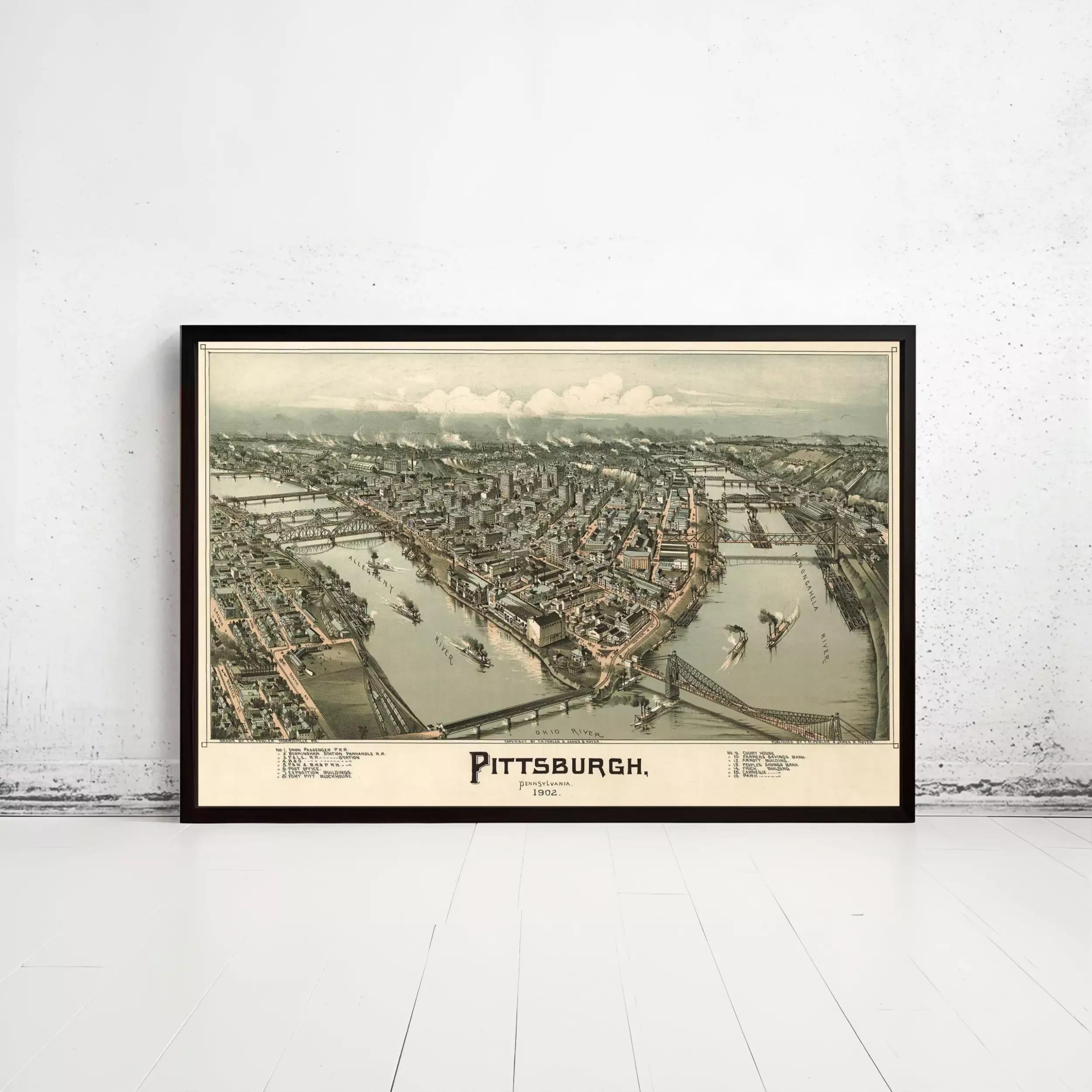 The image is a framed vintage map of Pittsburgh, Pennsylvania, depicting the city's layout and surrounding areas.