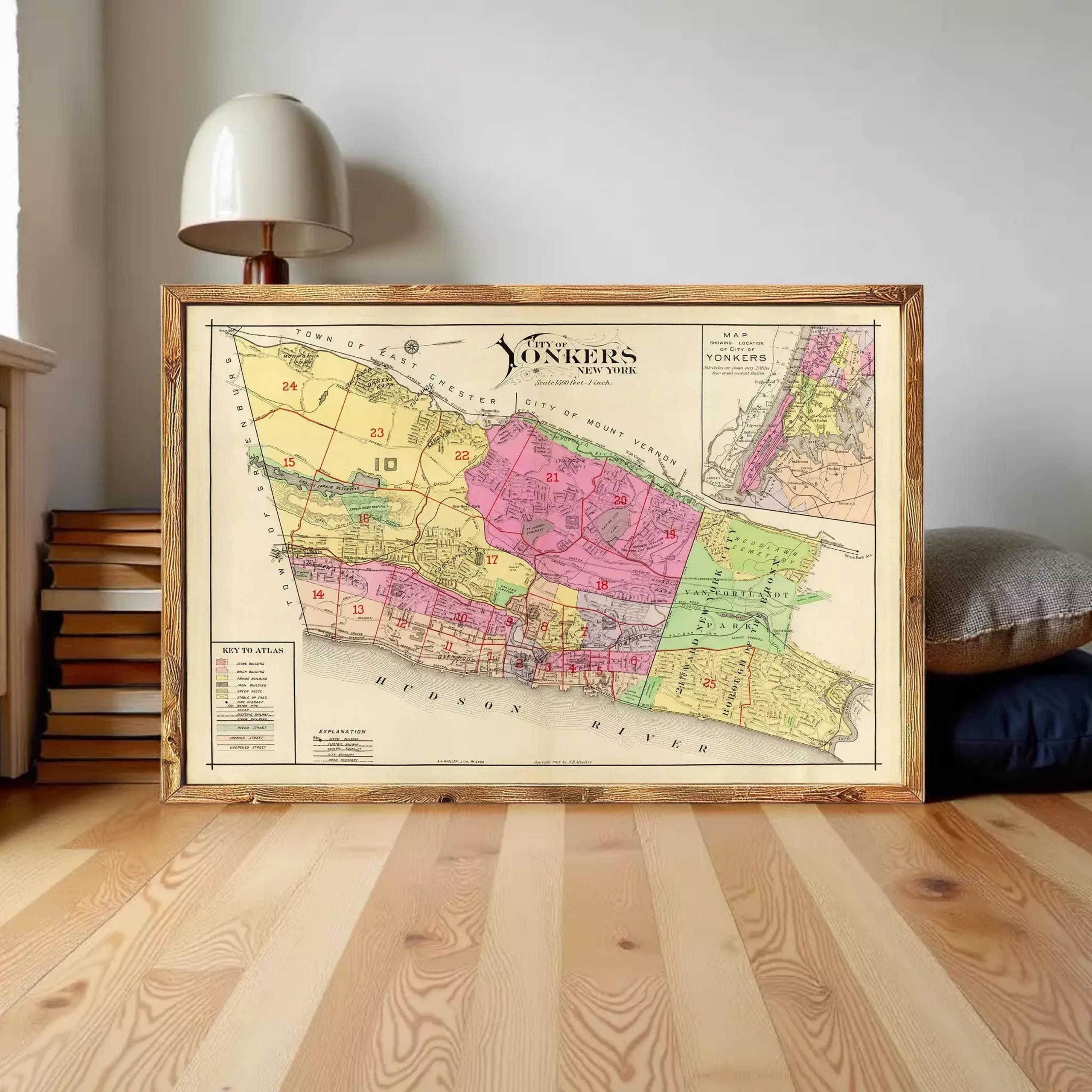 The image is a framed vintage map of New York, depicting the city in a colorful and detailed manner.