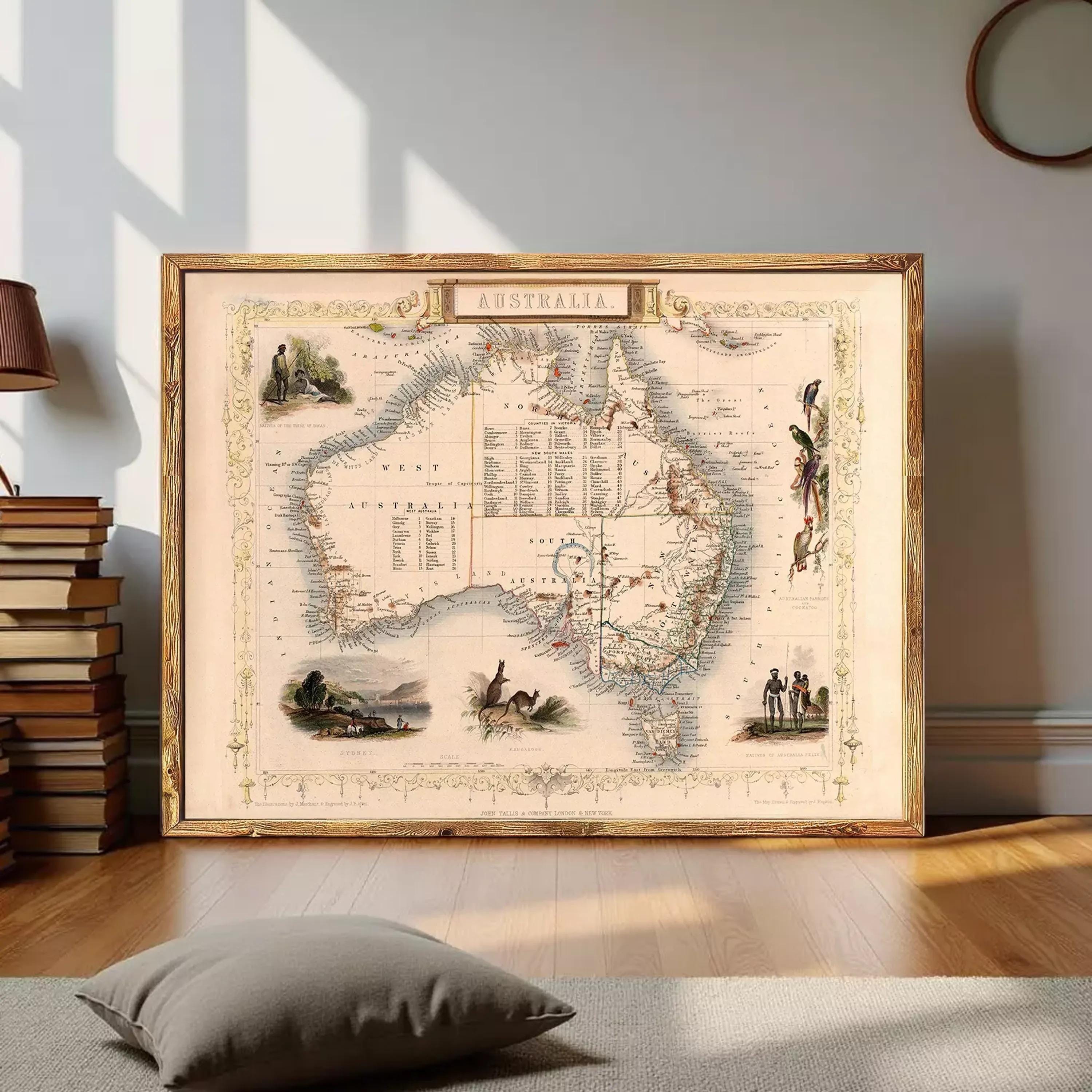 The image is a framed vintage map of Australia, featuring various illustrations and labels.