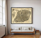 The image is a framed antique map of a city, likely from the 16th century, depicting a detailed layout of the city's streets and surrounding areas.