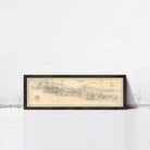 A framed map of Madagascar, a country in the South Pacific, is displayed against a white wall.
