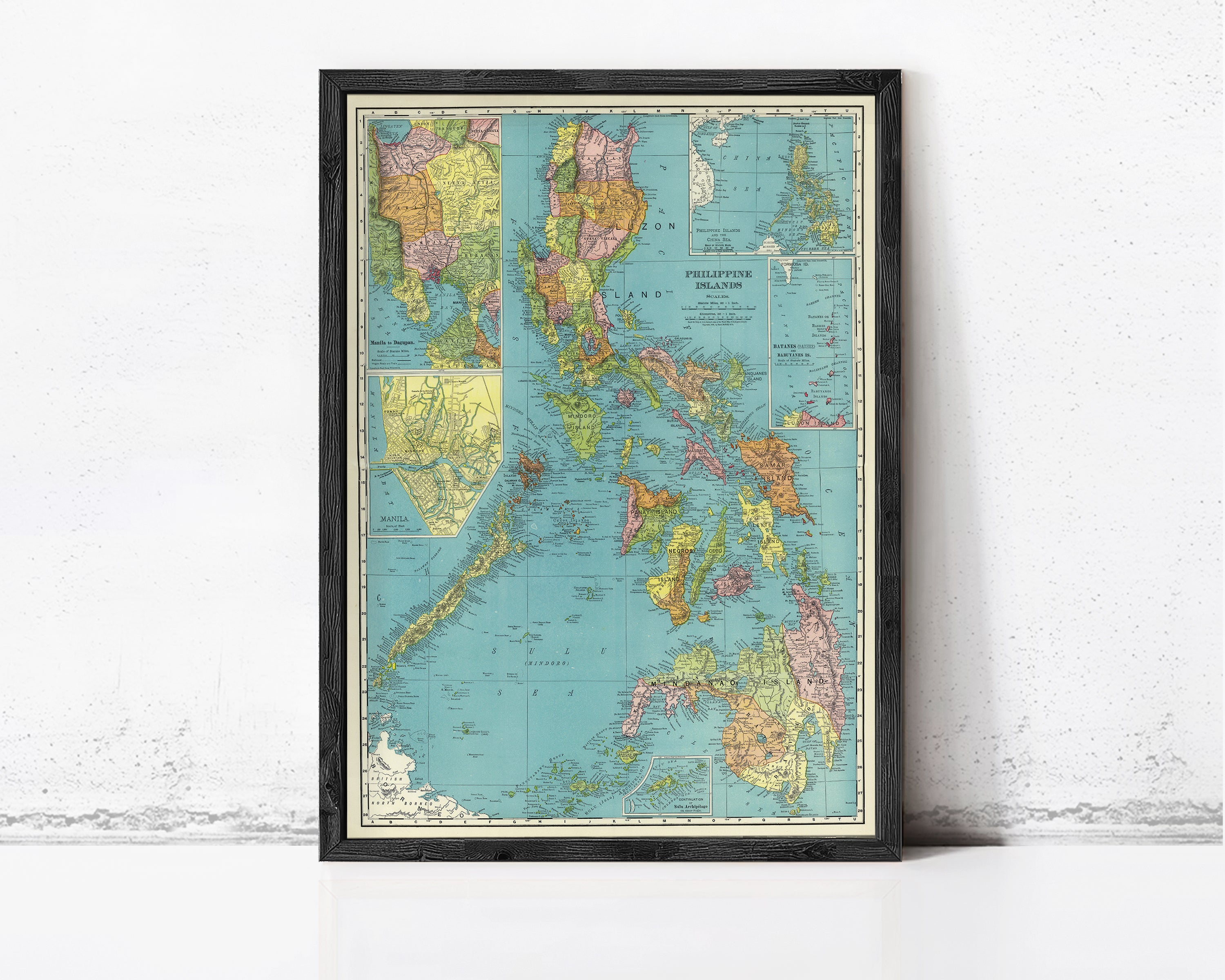 The image is a framed vintage map of the Philippines, showing the country's geographical layout and surrounding areas.