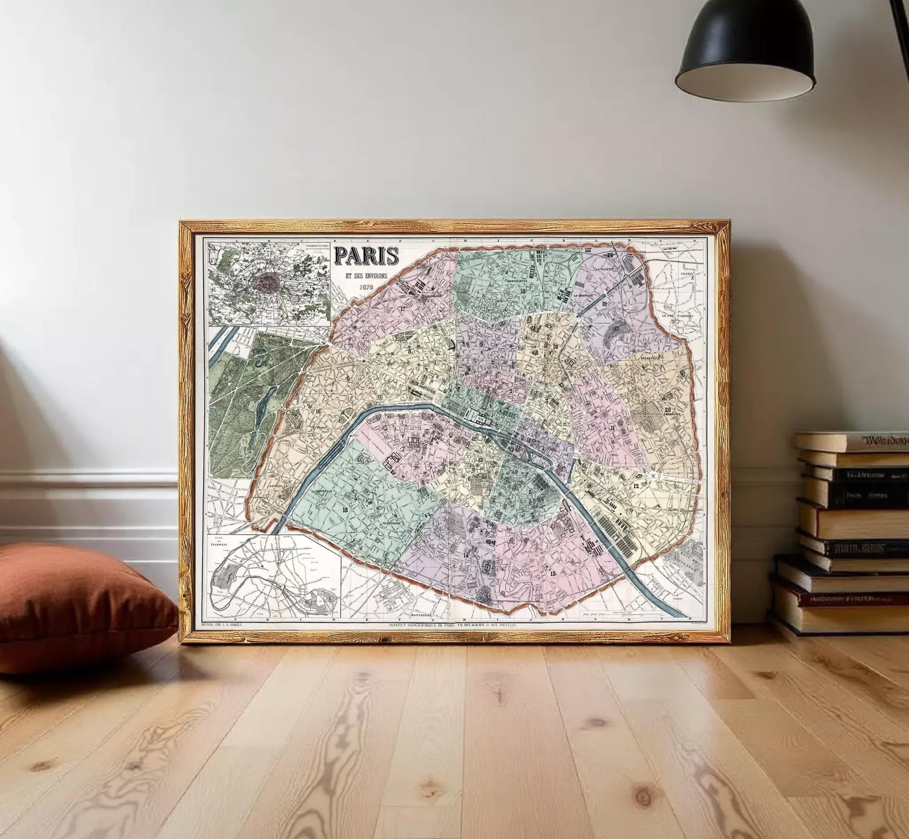 The image is a framed vintage map of Paris, France, depicting the city's streets and neighborhoods in a detailed and colorful manner.