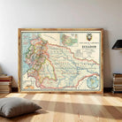 a large framed map of Ecuador, with a wooden frame and a black lamp to the right.
