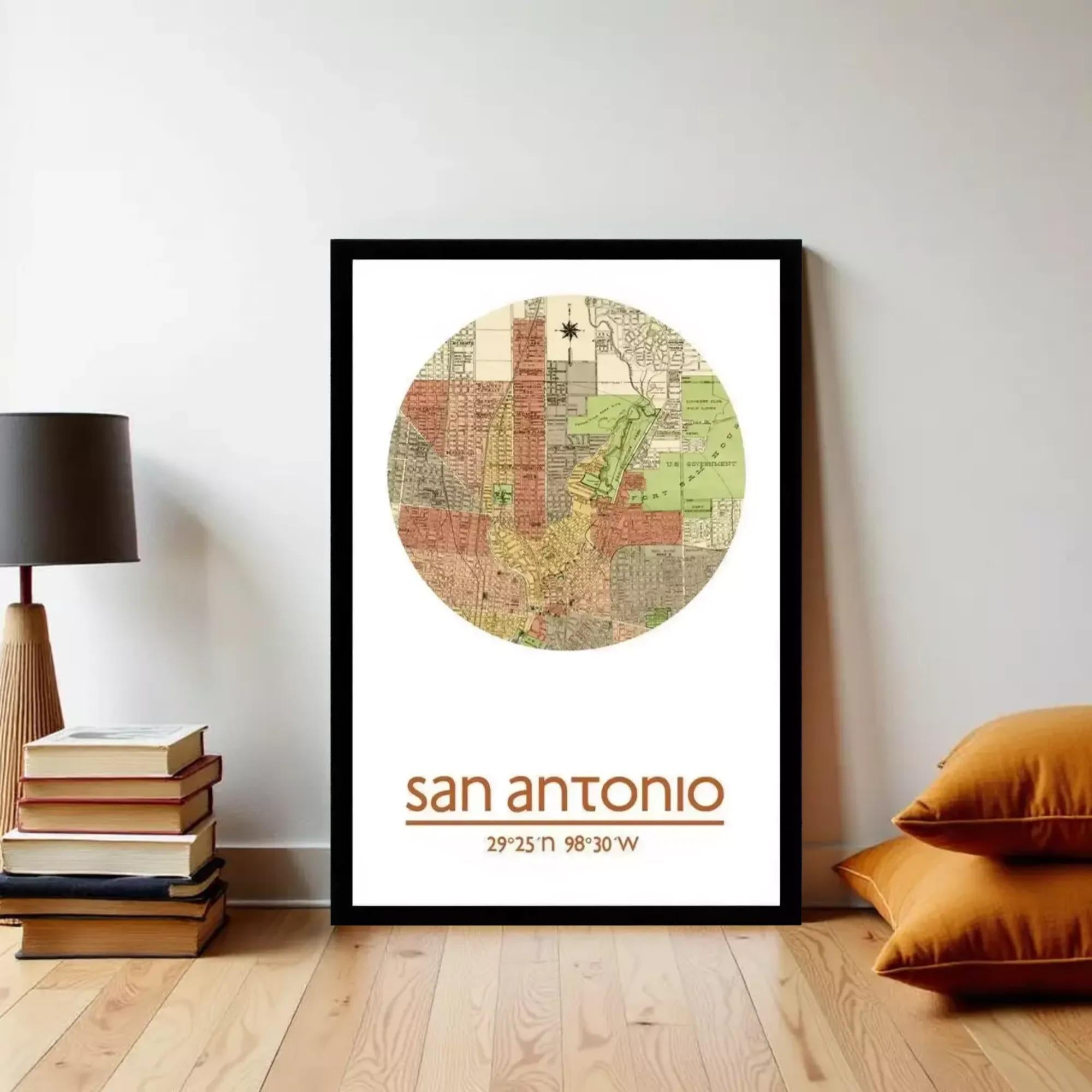 A framed map of San Antonio, Texas, with the city's location and surrounding area, is displayed on a wall in a room with a lamp and books.