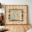 The image is a large framed map of a city, with various advertisements and information surrounding it.