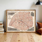 The image is a framed vintage map of Paris, France, depicting the city's streets and landmarks.