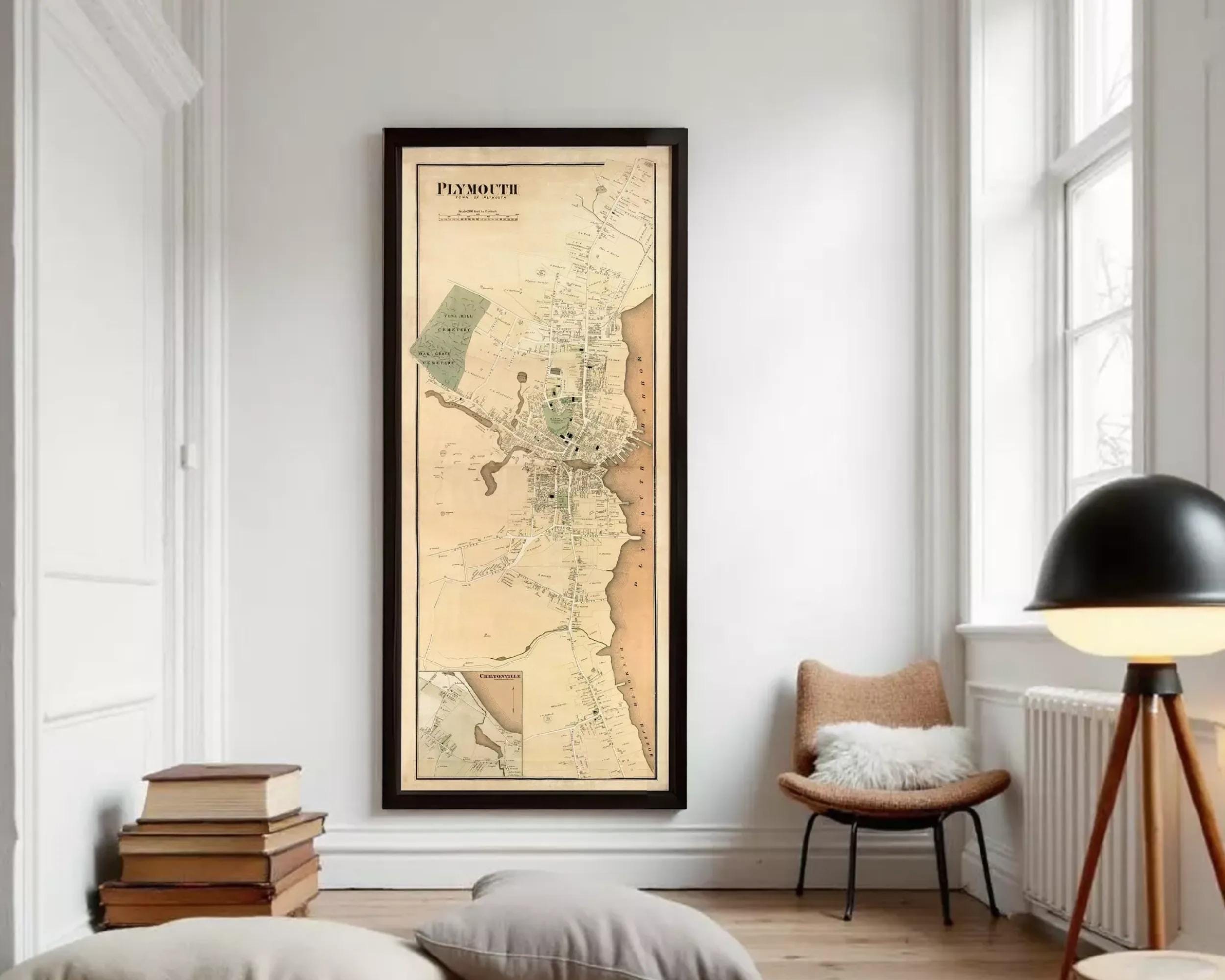 A framed map of Plymouth, Massachusetts, depicting the city's layout and surrounding areas.