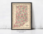 The image is a framed vintage map of Indiana, with a black border and a beige background.